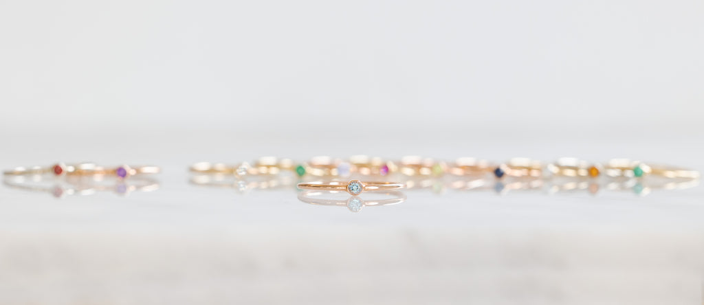 Birthstone Stacker Rings in a line with Aquamarine Stacker in the Forefront