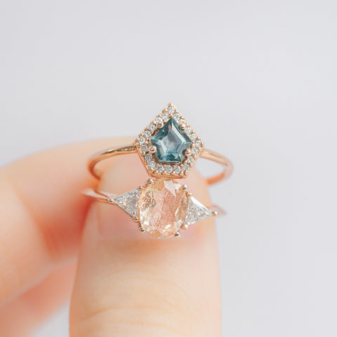 Sunstone and Sapphire Gemstone Engagement Rings in Model's Hand