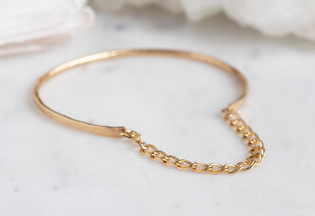 Yellow Gold Muse Bracelet on White Marble Tile