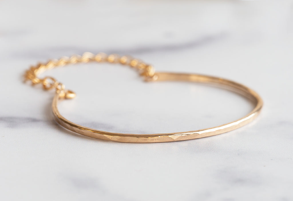 Yellow Gold Muse Bracelet on White Marble Tile