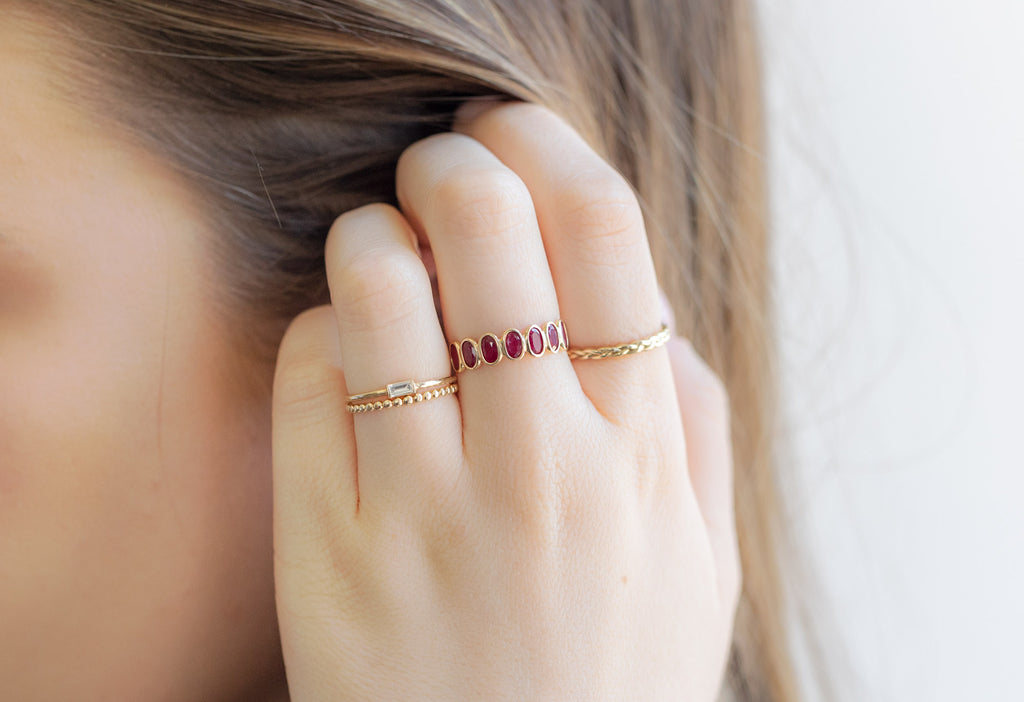 Ruby Gemstone Eternity Ring Stacked on Model Touching Her Hair