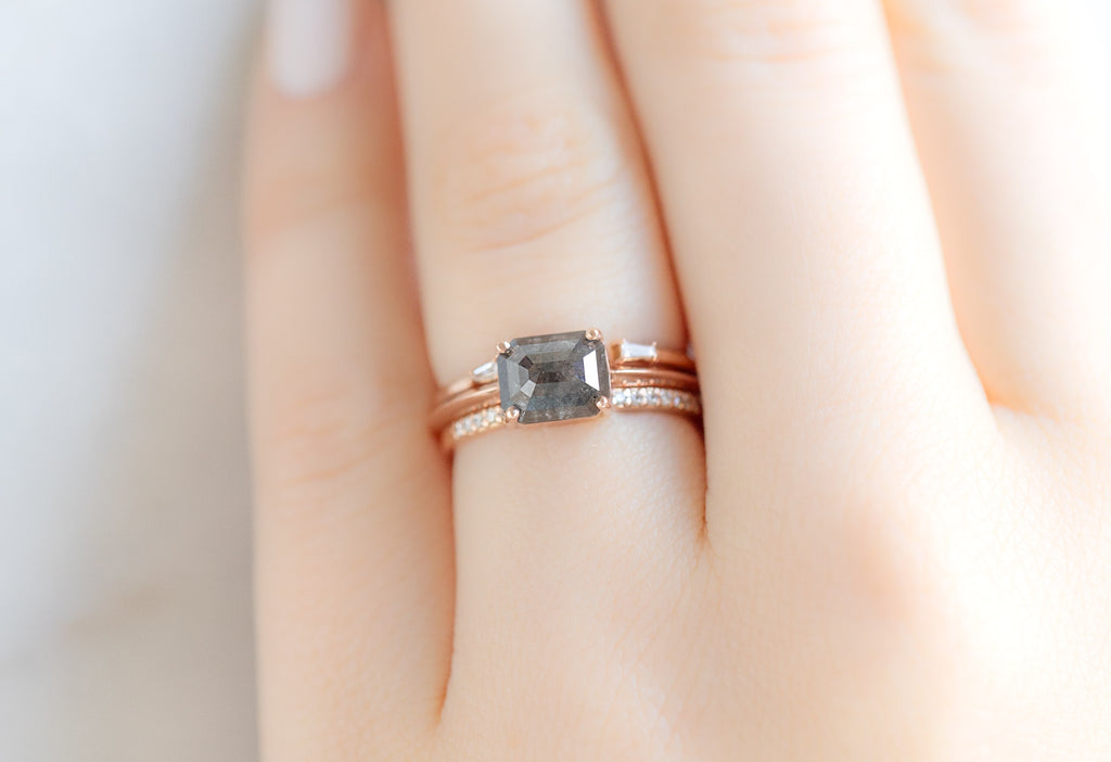 The Bryn Ring with an Emerald-Cut Black Diamond with White Diamond Stacking Bands on Model