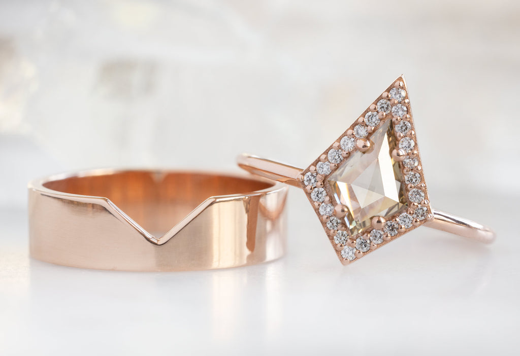 The Dahlia Ring with a Kite-Shaped Champagne Diamond leaning on The Gold Cut Out Stacking Band