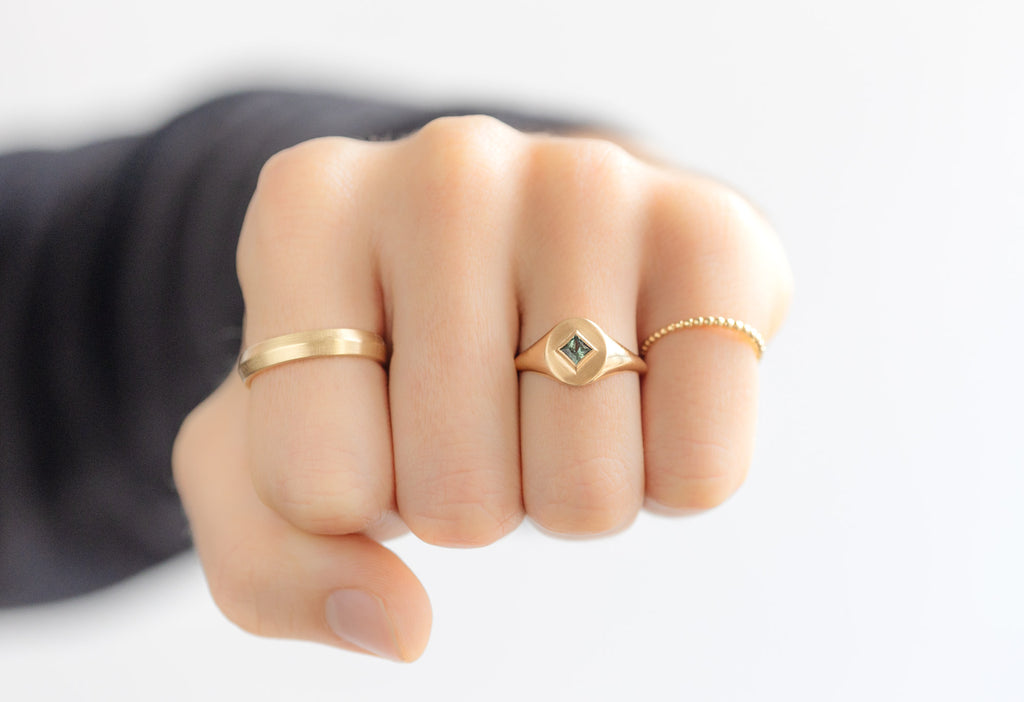 The Kite-Shaped Montana Sapphire Signet Ring Stacked on Model making a fist