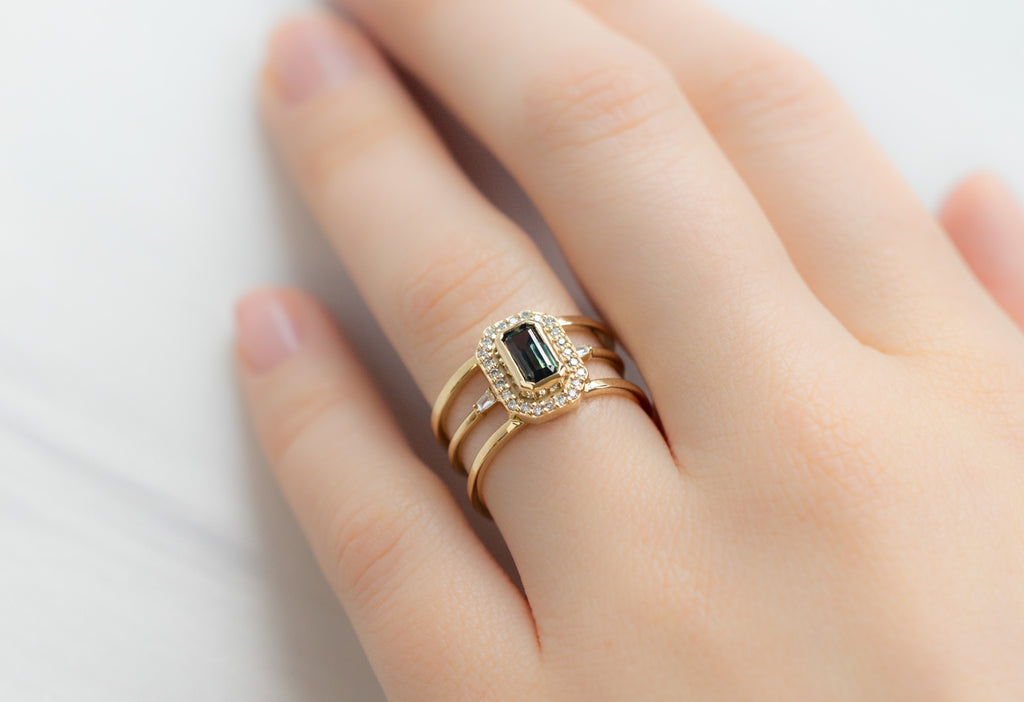 The Poppy Ring with an Emerald-Cut Montana Sapphire with Open Cuff Baguette Stacking Band on Model