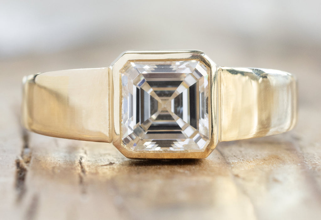 The Signet Ring with an Asscher-Cut Lab Grown Diamond on Wood Table